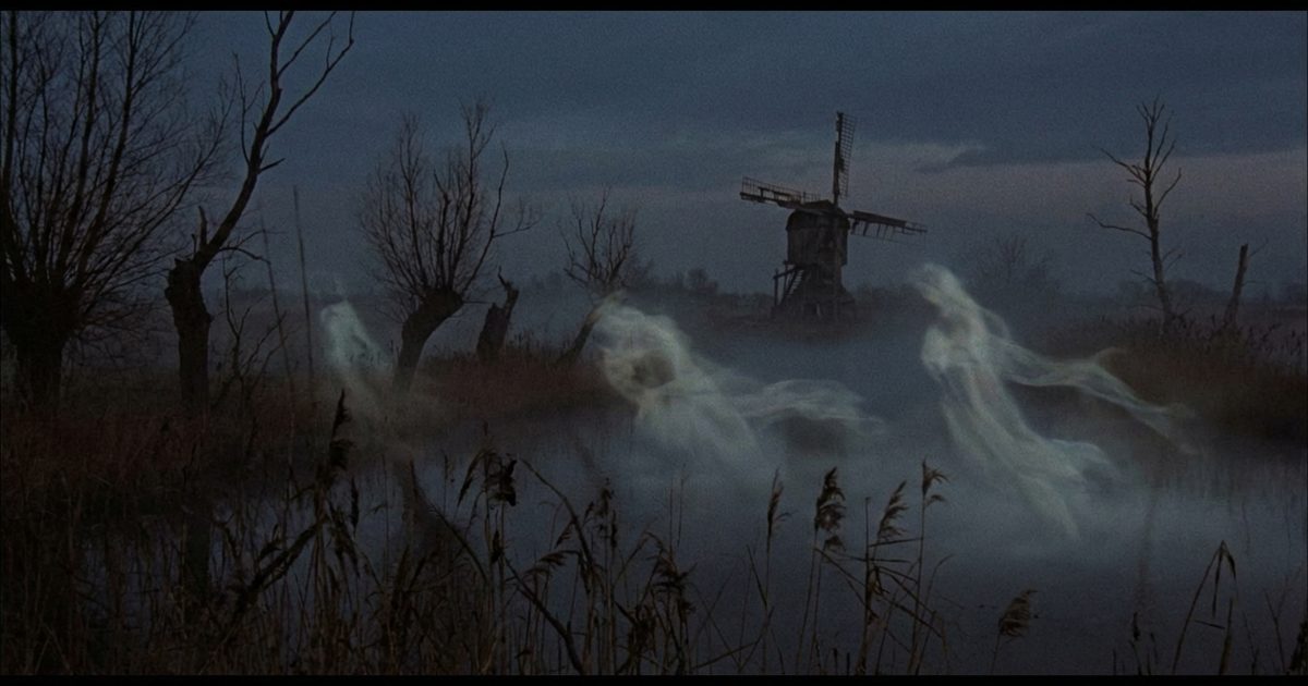 Amsterdam canals at night with dark legends, black water and dim lights